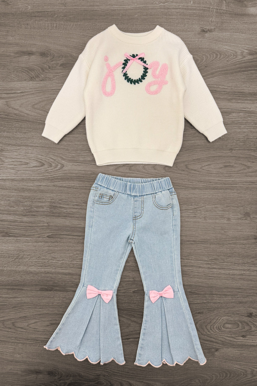 "Joy" Denim Flare Pant Set - 6-12 Months - Cream sweatshirt with a pastel pink graphic and embellished neckline, paired with light-wash denim flares featuring pink.