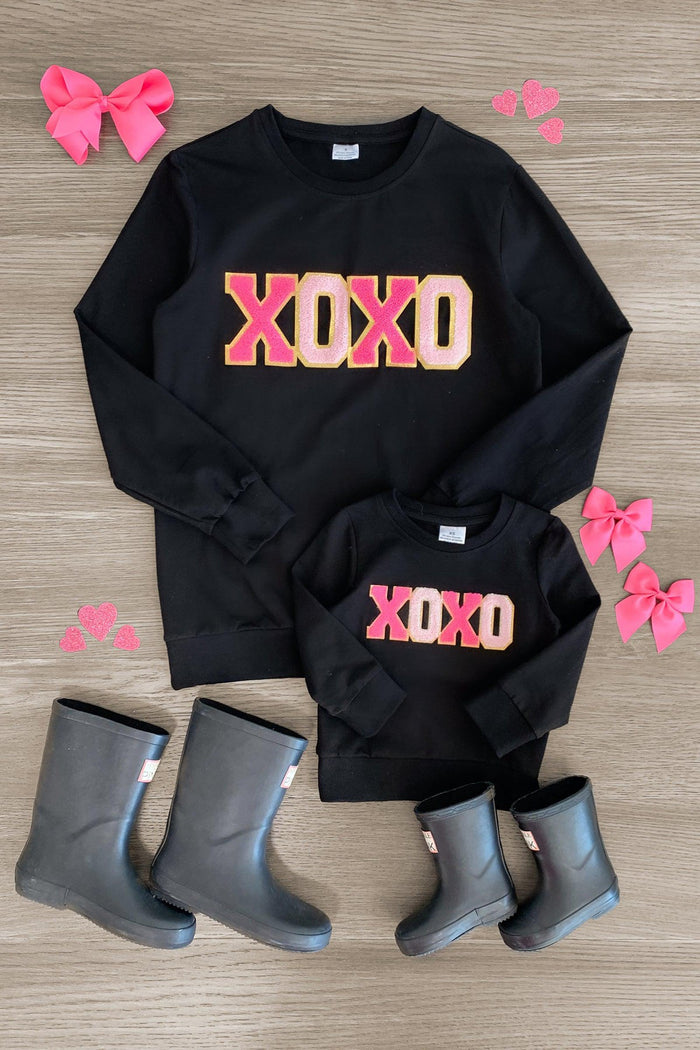 Mom & Me - "XOXO" Black Chenille Patch Top - BABY-0-3 Months-FAMILY - Black long-sleeve tops with pink and gold chenille "XOXO" patch, paired with gray boots and pink bows.