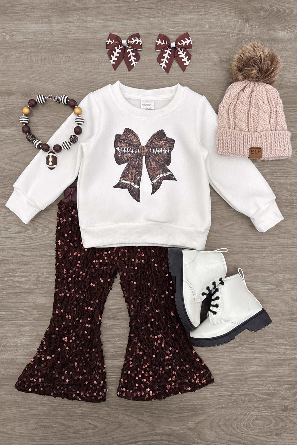 Bow Football Sequin Pant Set - 6-12 Months - White sweatshirt with a brown sequin football bow, paired with flared black sequin pants.