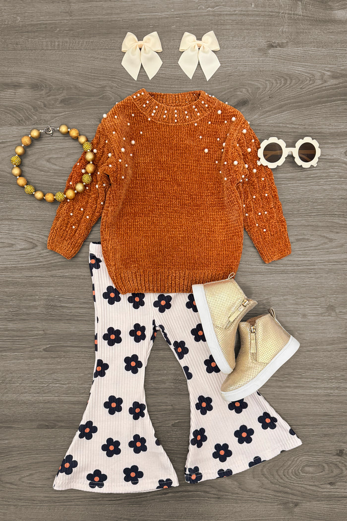 Rust Pearl Sweater Flower Bell Bottom Set - 3XS-6-12 Months - Rust orange knit sweater with eyelet floral details, paired with white bell-bottom pants featuring large black and orange.