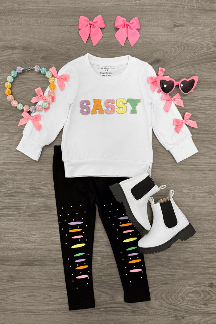 "Sassy" Rainbow Chenille Patch Legging Set - 3XS-6-12 Months - White long-sleeve shirt with colorful "SASSY" letters paired with black leggings with rainbow chenille patches and white.