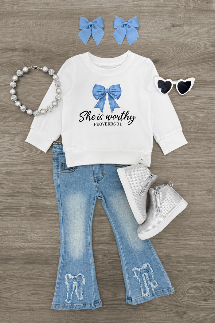 "She Is Worthy" Denim Bow Flare Pant Set - 6-12 Months - White long-sleeve top with blue bow and "She is worthy" text, light denim flare pants with embroidered bows, white boots,.