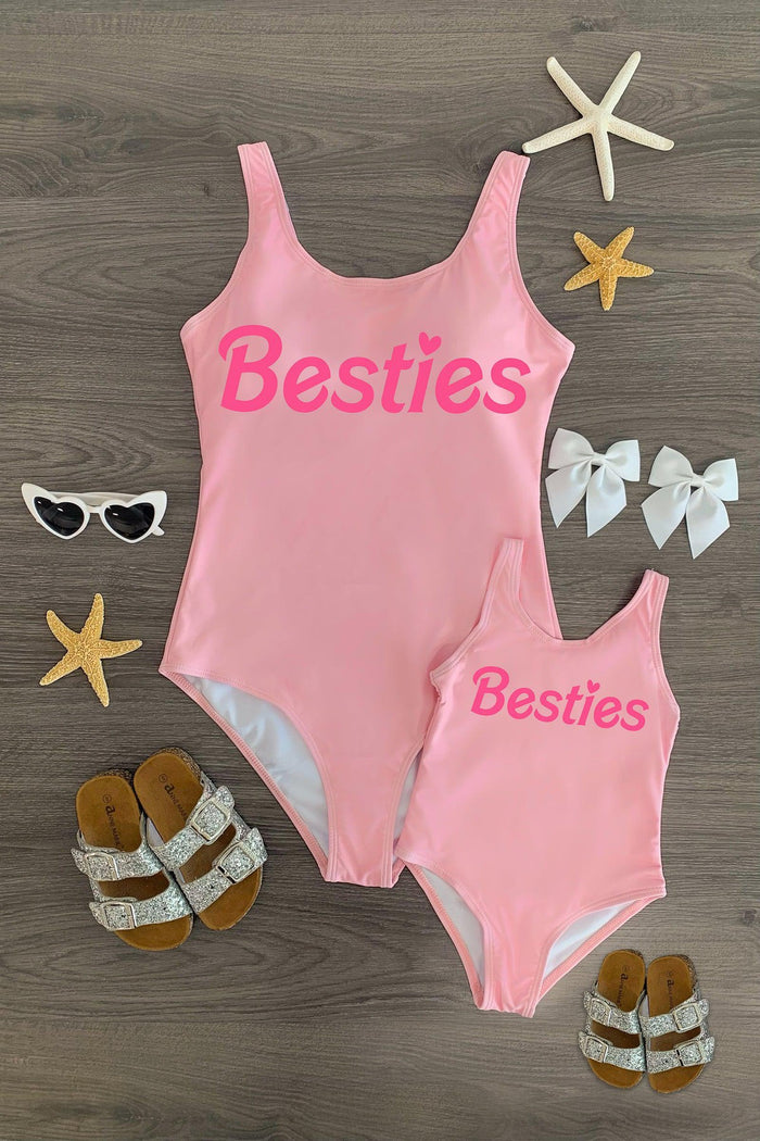 Mom & Me - "Besties" Pink One Piece Swimsuit - CHILD-3XS-6-12 Months - Matching pink one-piece swimsuits with "Besties" in bold pink letters, adult and child sizes shown with sandals and.