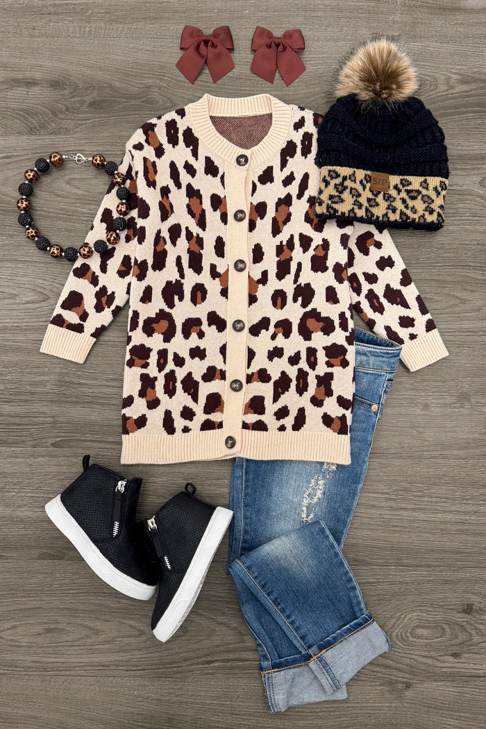 Cheetah Button Down Cardigan - 3XS-6-12 Months - Tan cheetah print button-down cardigan with brown spots and ribbed cuffs and hem on wooden background.