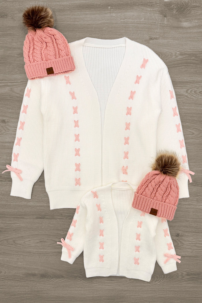 Mom & Me - Cream Lace-Up Bow Cardigan - CHILD-3XS-6-12 Months - Cream knit cardigans with pink lace-up bow details on sleeves and front, paired with matching pink knit hats with faux fur.