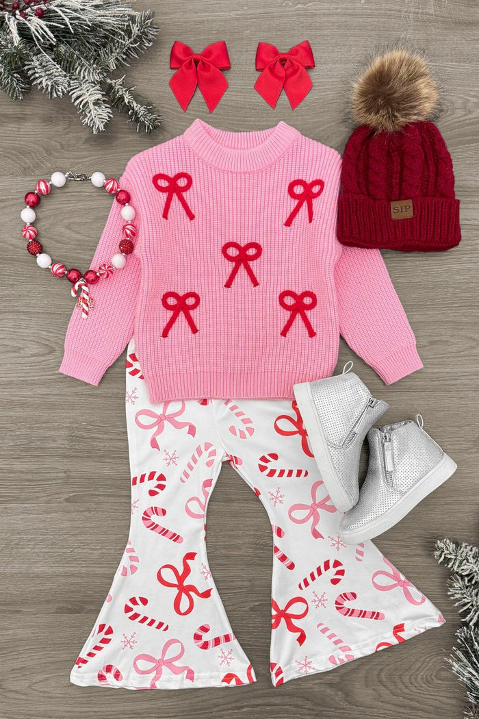 Pink Sweater Candy Cane Flare Set - 3XS-6-12 Months - Pink sweater with red bow accents, white flare pants with candy cane and bow print, red knit hat with pom-pom, red bow hair.