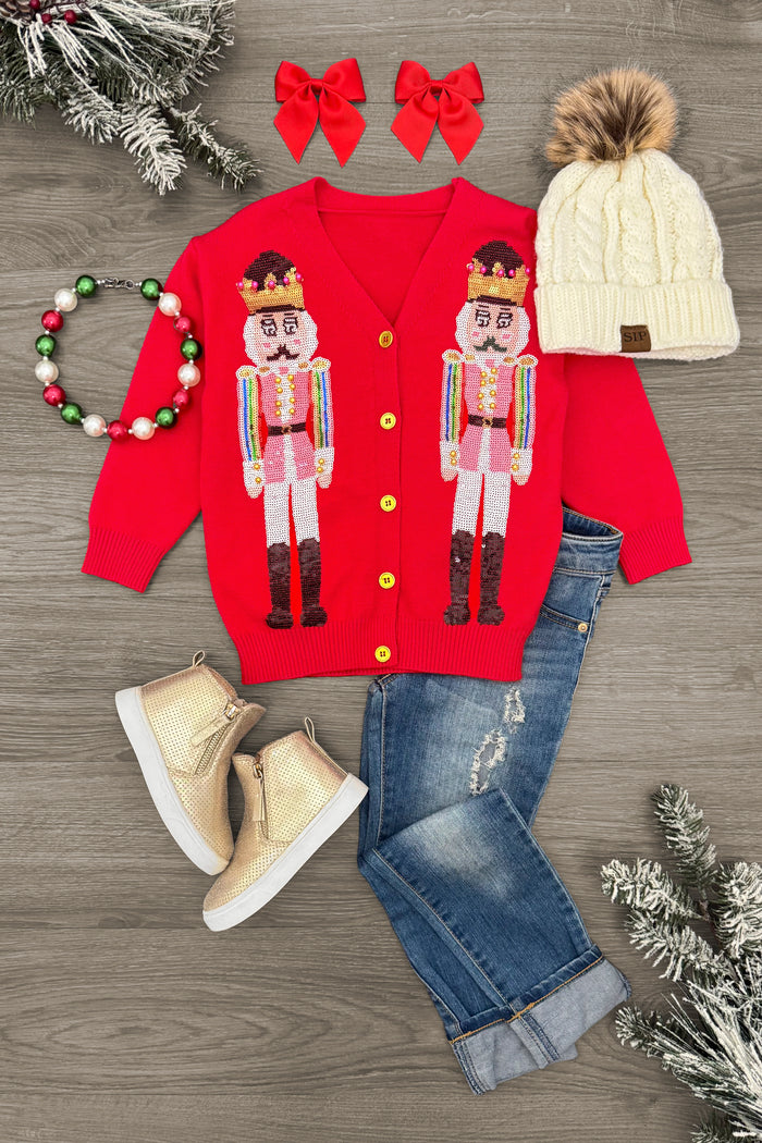 Red Sequin Nutcracker Sweater - 0-3 Months - Red sequin nutcracker sweater with gold buttons, paired with blue rolled cuff jeans, cream knit hat with faux fur pom-pom,.