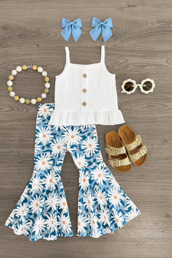White & Blue Daisy Bell Bottom Set - 6-12 Months - White sleeveless top with buttons paired with blue daisy print bell-bottom pants and matching blue bow hair clips, styled.