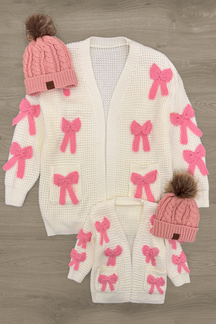 Mom & Me - Cream Knit Bow Cardigan - CHILD-3XS-6-12 Months - Cream knit cardigan with pink bows, available in adult and child sizes, styled with pink pom-pom beanies.
