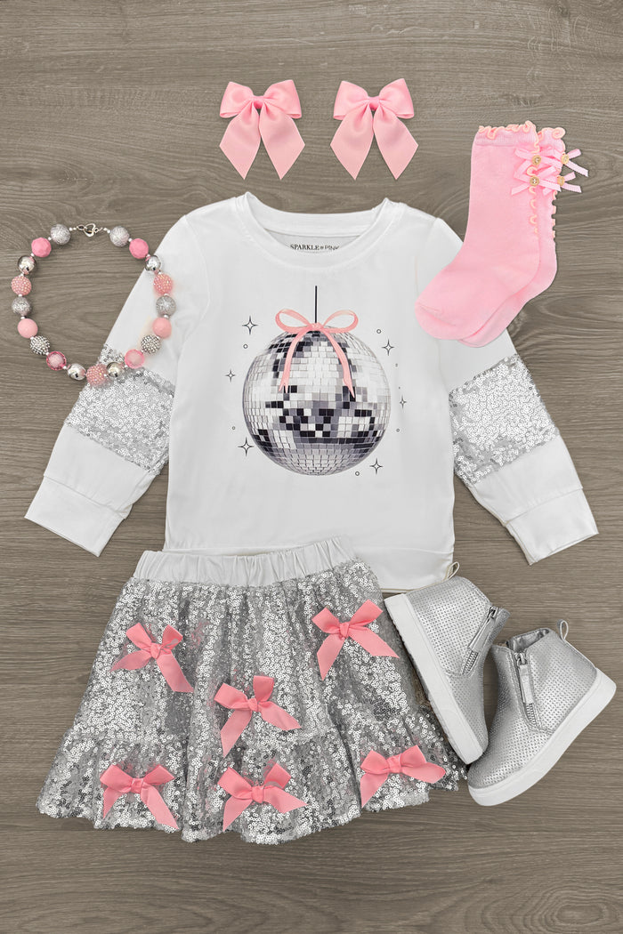 Silver Sequin Disco Skirt Set - 3XS-6-12 Months - White long-sleeve shirt with disco ball graphic, silver sequin skirt with pink bows, pink socks, silver boots, pink bow hair .