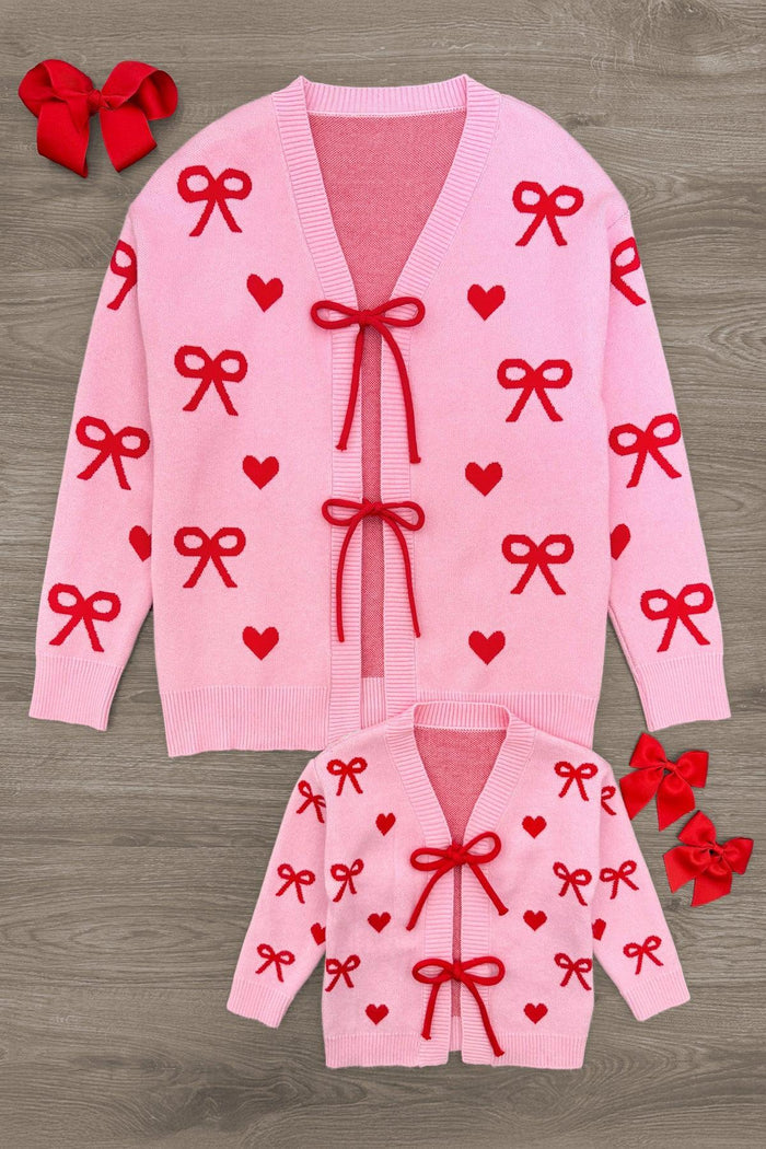 Mom & Me - Pink Heart & Bow Sweater Cardigan - CHILD-3XS-6-12 Months - Pink knit cardigan with red heart and bow patterns, two red bow ties on front closures, matching adult and child sizes.