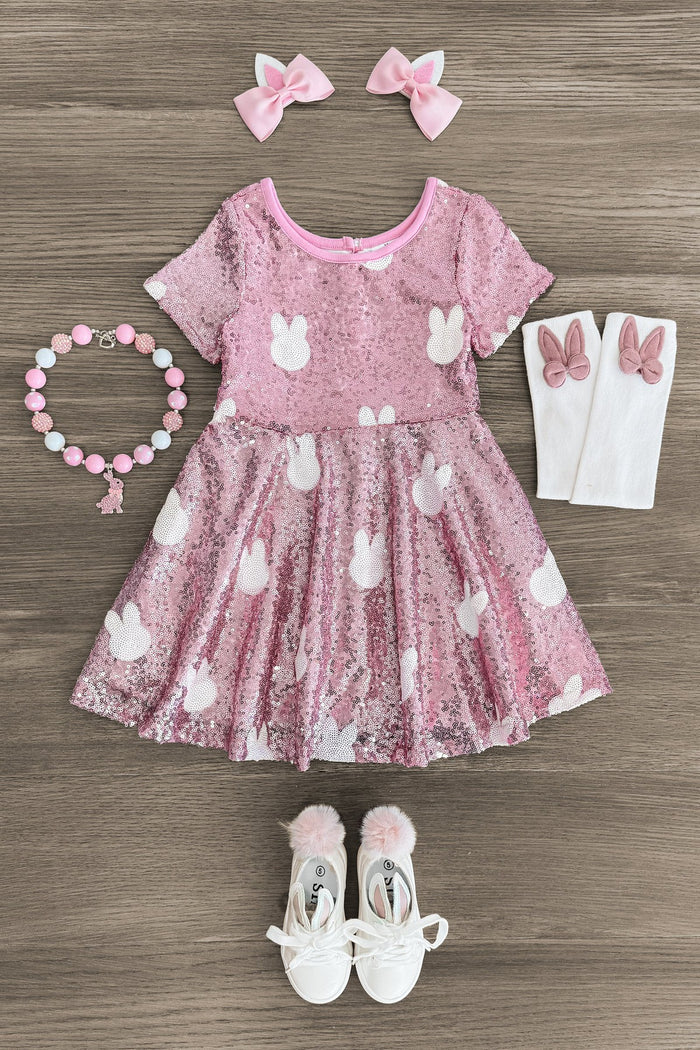 Pink Sequin Bunny Dress - 3XS-6-12 Months - Pink sequin toddler dress with white bunny motifs, matching bow clips, beaded bracelet, bunny-accented socks, and metallic.