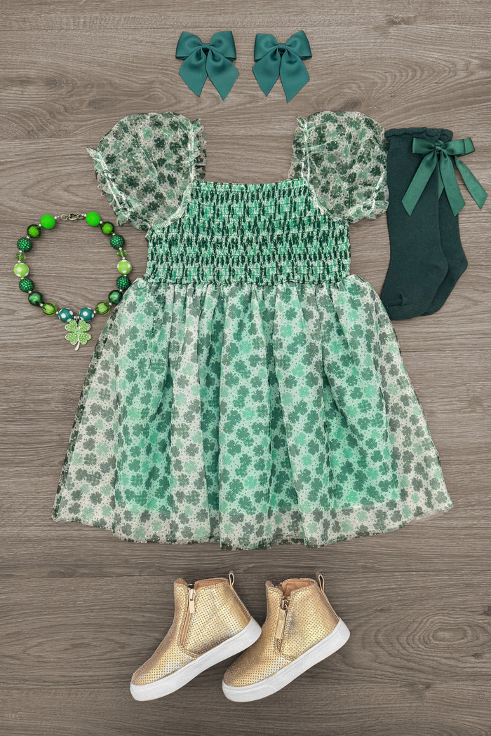 Shamrock Tulle Glitter Dress - 6-12 Months - Green shamrock print tulle dress with puff sleeves and smocked bodice, paired with green socks, matching hair bows, beaded.