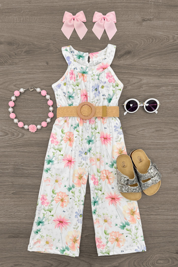 Watercolor Floral Jumpsuit - 6-12 Months - White sleeveless jumpsuit with watercolor floral print, brown belt buckle, paired with pink bow clips, beaded necklace,.