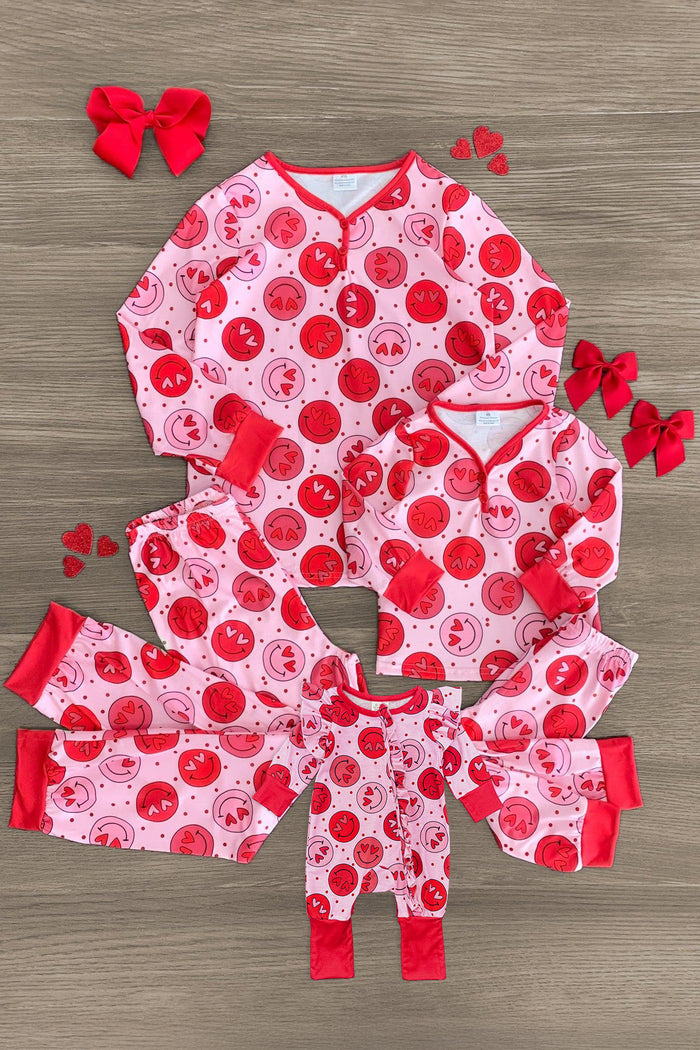 Mom & Me - Pink & Red Smiley Heart Pajamas - BABY-Newborn - Matching pink and red pajamas with smiley heart pattern for mom, baby, and child, featuring red cuffs and neckline, styled.
