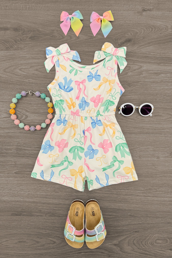 Pastel Bows Romper - 6-12 Months - Cream romper with pastel rainbow bows, ruffled sleeves, paired with matching pastel bow clips, beaded bracelet, white.