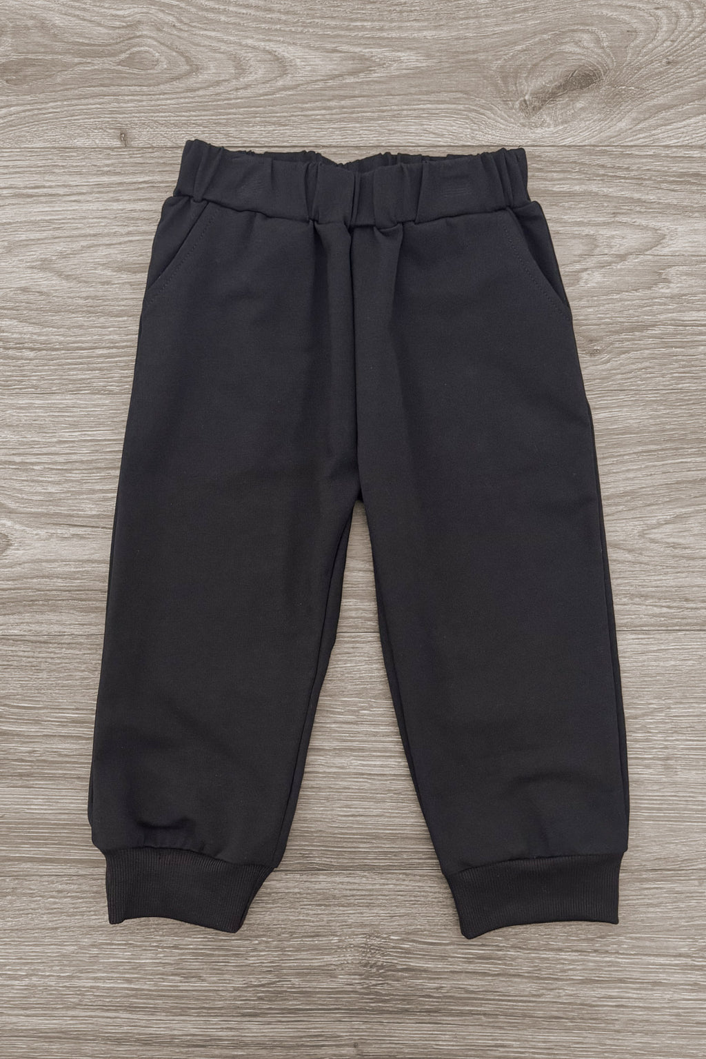 Ghost Pant Set - Boy Or Girl - GIRL-6-12 Months-FAMILY - Black toddler pants with elastic waistband and cuffed ankles on light wood floor background.