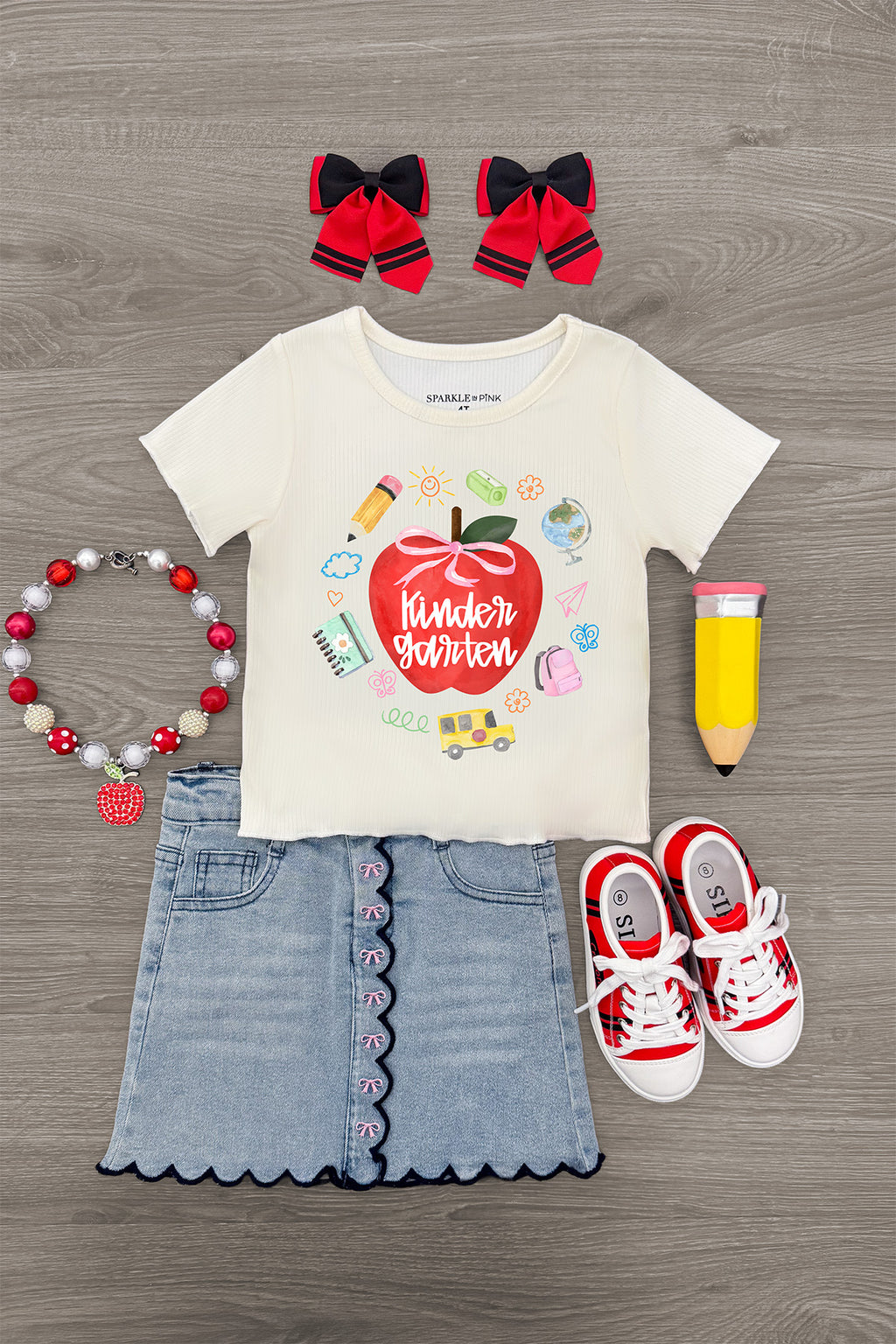 "Pre-K - Fifth Grade" Apple Denim Skirt Set - PRE-K / 2T - Cream short-sleeve tee with colorful apple graphic, light denim skirt with scalloped hem, red and white sneakers, red hair.