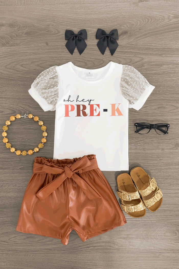 "Oh Hey Pre-K - 6th Grade" Pleather Short Set - PRE-K / XS-2T - White short-sleeve top with "oh hey PRE-K" print and puffed lace sleeves, brown pleather tie waist shorts, brown sandals,.