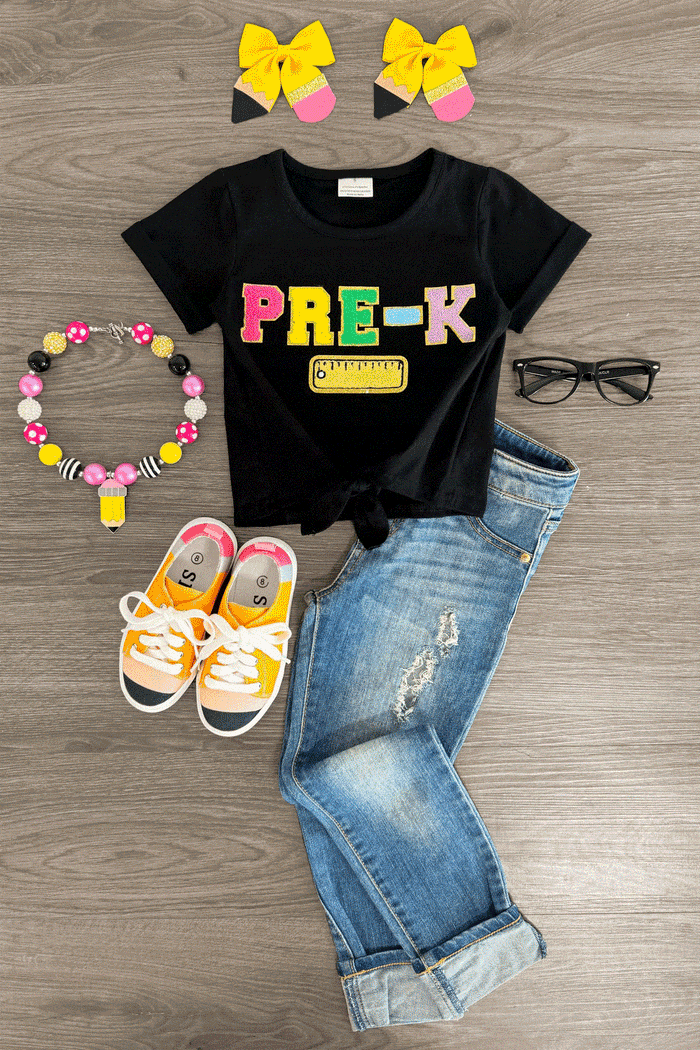 "Pre-K - Sixth Grade" Rainbow Chenille Patch Top - PRE-K / XXS-12-18 Months - Black t-shirt with rainbow chenille "PRE-K" patch paired with rolled cuff jeans and yellow sneakers.