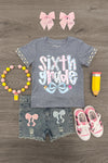 "Pre-K - Sixth Grade" Plaid Bow Denim Short Set - SIXTH GRADE / 12 - Gray short-sleeve shirt with pink and white glitter "Sixth Grade" text, distressed denim shorts with pink and white bows,.