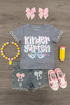 "Pre-K - Sixth Grade" Plaid Bow Denim Short Set - KINDERGARTEN / 3T - Gray short-sleeve shirt with plaid bow sleeves and "Kindergarten" graphic, distressed denim shorts with plaid bows, pink.