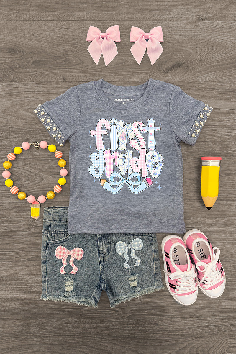 "Pre-K - Sixth Grade" Plaid Bow Denim Short Set - FIRST GRADE / 4T - Gray short-sleeve shirt with "first grade" text and plaid bow accents, denim shorts with plaid bow patches, pink sneakers,.