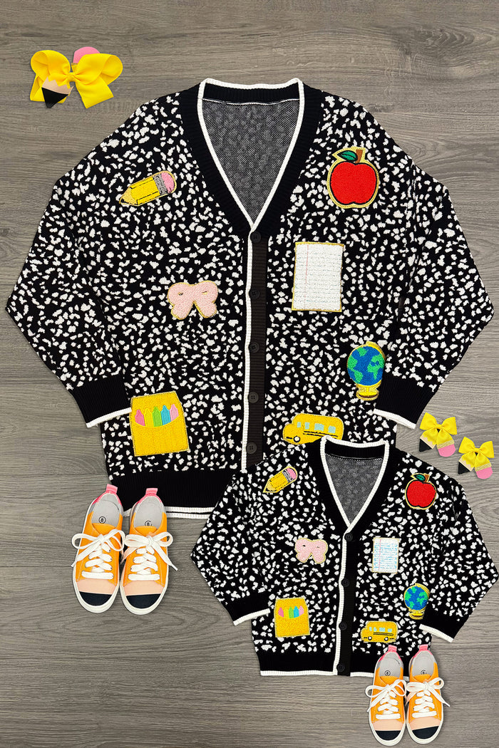 Mom & Me - Composition Sweater Cardigan - CHILD-3T - Black sweater cardigans with white floral patterns, white trim, and front pockets in adult and child sizes.