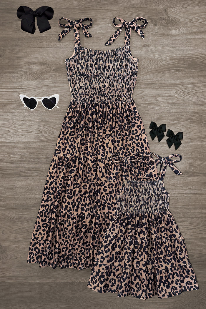 Mom & Me - Cheetah Print Dress - CHILD-6-12 Months - Matching mom and child sleeveless cheetah print dresses with tie straps, paired with black and white heart-shaped sunglasses .