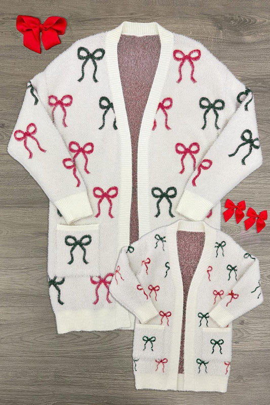 Mom & Me - Cozy Red & Green Bow Cardigan - CHILD-6-12 Months - Cream cardigan with repeated red and green bow patterns, long sleeves, button-down front, and pockets on larger size and.