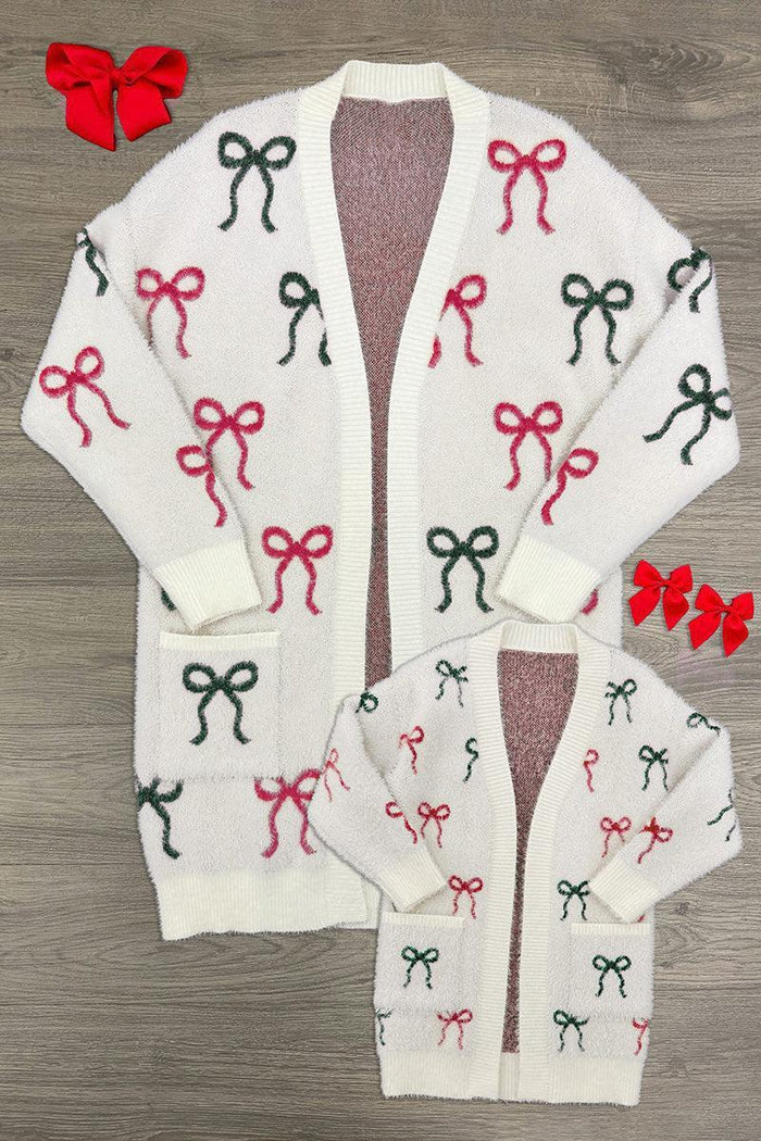 Mom & Me - Cozy Red & Green Bow Cardigan - CHILD-6-12 Months - Cream cardigan with repeated red and green bow patterns, long sleeves, button-down front, and pockets on larger size and.