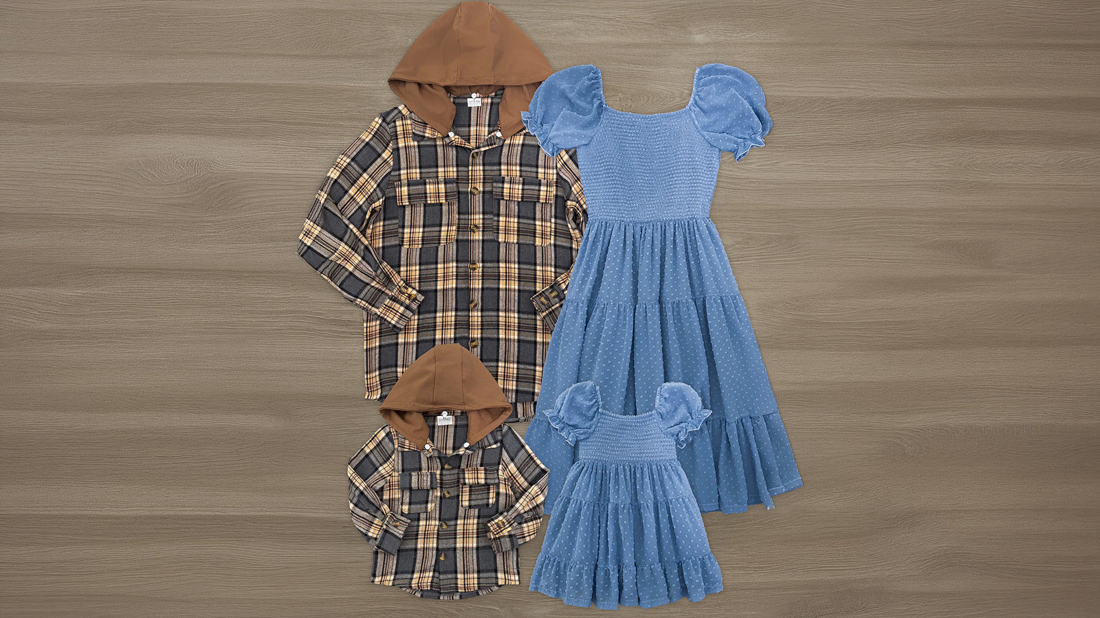 Family matching fall outfits with women and girls in blue swiss dot dresses and men and boys in brown plaid flannel hoodies