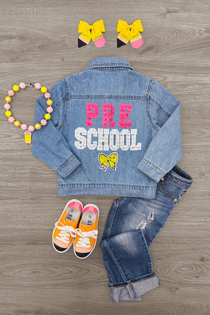 "Preschool - Sixth Grade" Denim Jacket - PRESCHOOL / 3T - Light blue denim jacket with "PRE SCHOOL" in pink and white letters and yellow bows on the back.