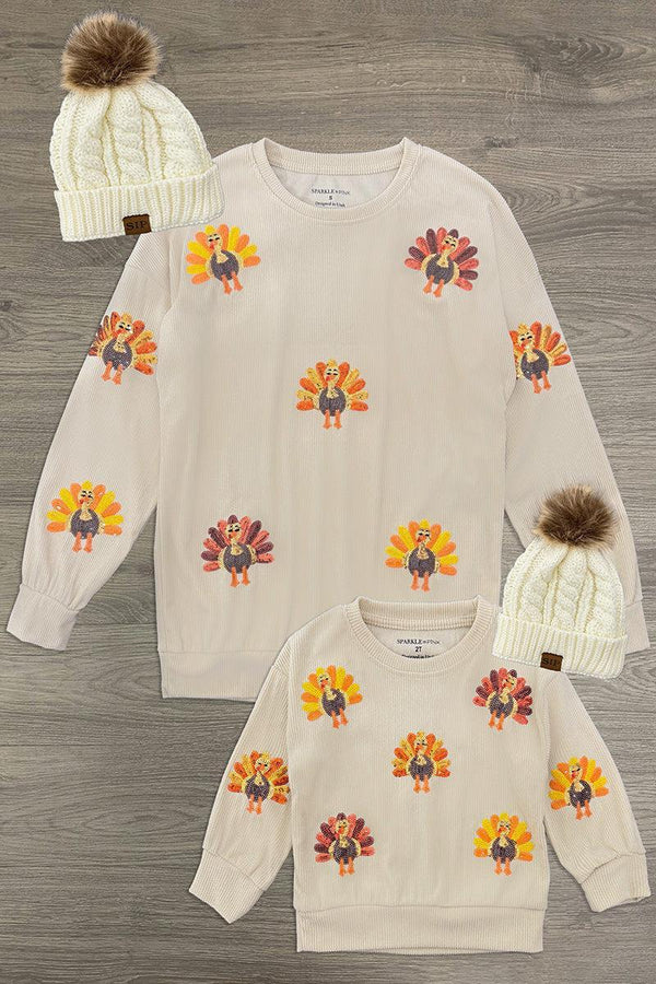 Mom & Me - Corduroy Sequin Turkey Top - CHILD-6-12 Months - Cream long-sleeve tops with colorful sequin turkey motifs, paired with cream knit pom-pom beanies.
