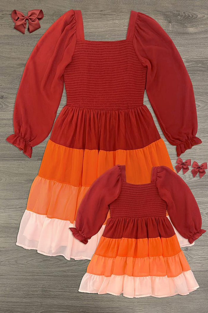 Mom & Me - Fall Ruffle Ombre Dress - CHILD-6-12 Months - Two matching fall ruffle dresses in rust, orange, pink, and cream ombre with smocked bodices and puffed long sleeves.