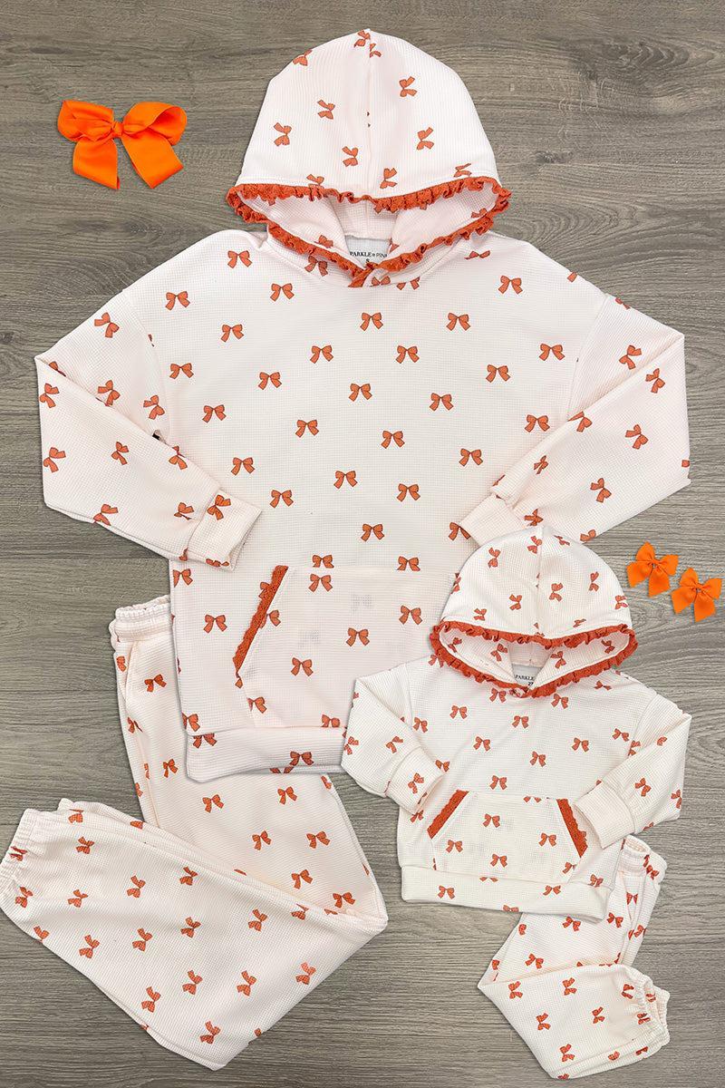 Mom & Me - Waffle Knit Bow Lounge Set - CHILD-6-12 Months - Cream waffle-knit hooded lounge sets with orange bows, shown in adult and child sizes, plus matching bow clips.