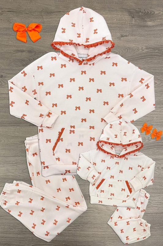 Mom & Me - Waffle Knit Bow Lounge Set - CHILD-6-12 Months - Cream waffle-knit hooded lounge sets with orange bows, shown in adult and child sizes, plus matching bow clips.