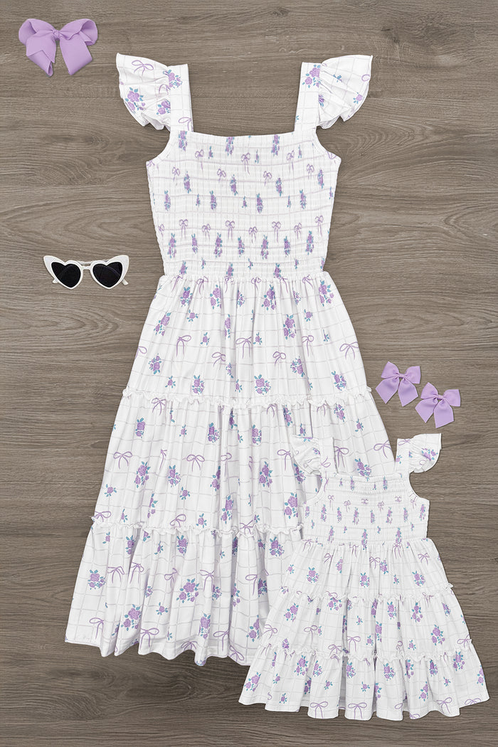 Mom & Me - Floral Bows Checkered Dress - CHILD-6-12 Months - White tiered dress with purple floral pattern and flutter sleeves, styled with matching bows and heart-shaped sunglasses.