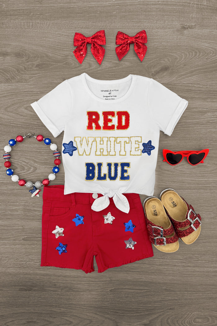 "Red, White, Blue" Red Denim Short Set - 6-12 Months - White short-sleeve tee with red, white, and blue "Red White Blue" text, red shorts with star patches, red bow headbands,.