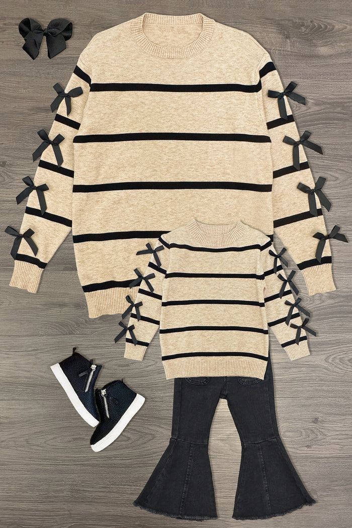 Mom & Me - Striped Bow Sweater & Denim Pant Set - CHILD-3XS-6-12 Months - Tan striped sweater with black bows on sleeves in adult and child sizes, paired with black sneakers and bow hair clips.
