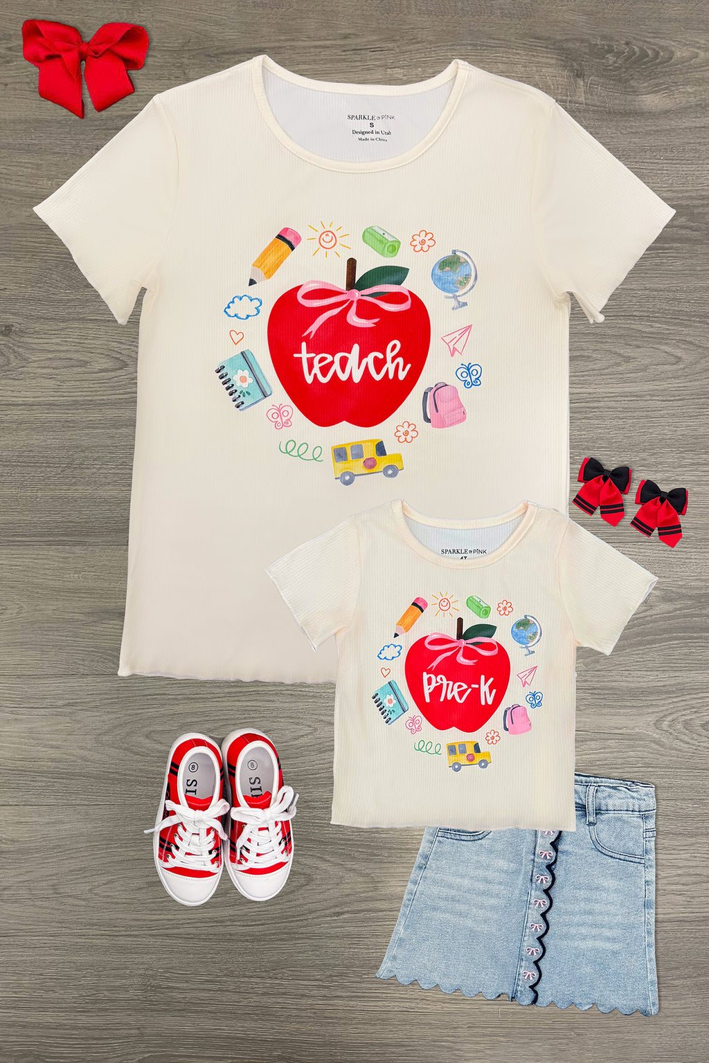 "Teach" Apple Top - MOM-XS - Cream short-sleeve top with red apple graphic and "teach" text surrounded by school-themed icons.