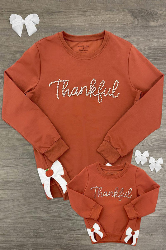 Mom & Me - "Thankful" Bow Pullover - CHILD-6-12 Months - Rust-colored long-sleeve pullover with "Thankful" script and white bow accents on cuffs, adult and child sizes.