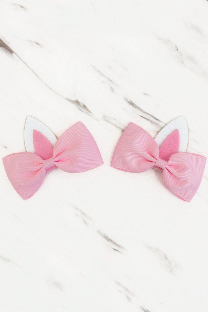 2 PACK - Sweet Bunny Ears Bow Set - Default Title - Two pastel pink fabric bows with white bunny ears on a light marble surface.