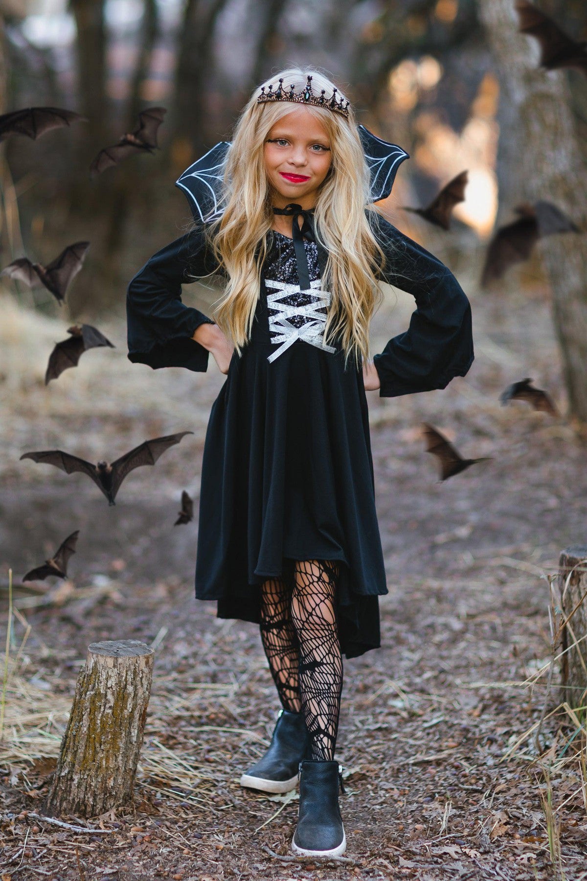 Vampire Queen Costume - XXS-12-18 Months - Black long-sleeve velvet vampire dress with white lace-up front and high collar, worn with spiderweb tights and a tiara.