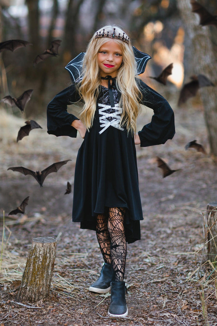 Vampire Queen Costume - XXS-12-18 Months - Black long-sleeve velvet vampire dress with white lace-up front and high collar, worn with spiderweb tights and a tiara.