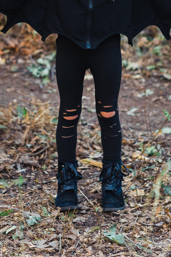 Mom & Me - Black Distressed Leggings - CHILD-2XS-12-18 Months - Black distressed leggings with ripped knees worn with black boots and layered black top outdoors.