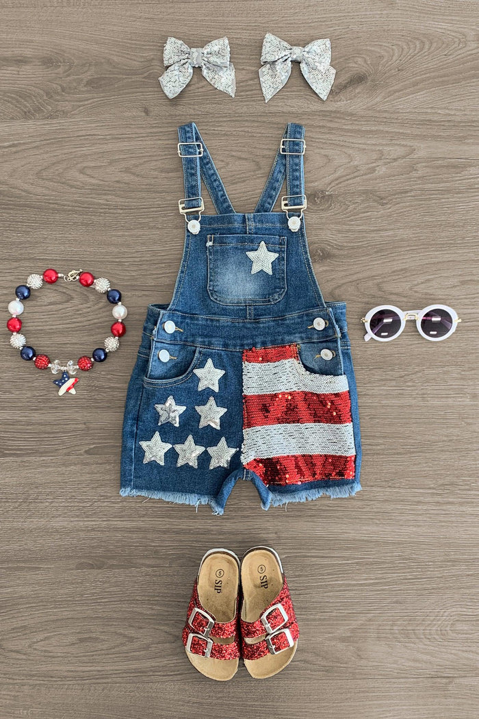 Stars & Stripes Sequin Denim Overalls - 0-3 Months - Toddler denim overalls with American flag sequin stars and stripes, paired with red sandals, white bow clips, beaded.
