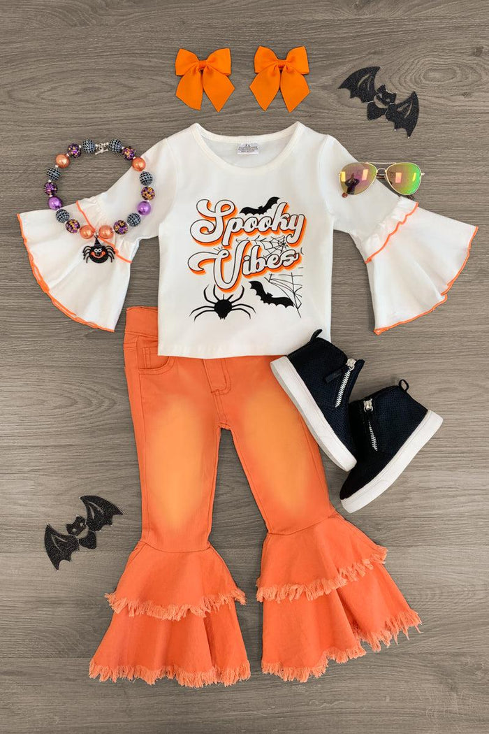 "Spooky Vibes" Denim Bell Bottom Set - 3XS-6-12 Months - White long-sleeve top with orange ruffled cuffs and "Spooky Vibes" text paired with orange denim bell-bottom pants and black .