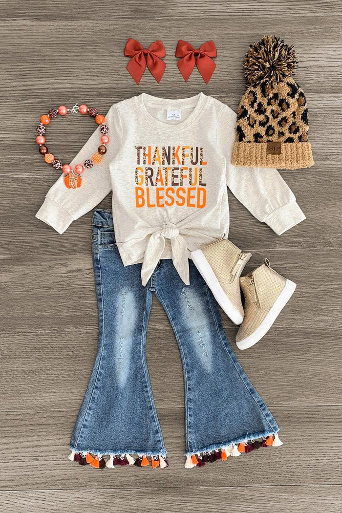"Thankful Grateful Blessed" Denim Flare Set - 3XS-6-12 Months - Cream long-sleeve top with "Thankful Grateful Blessed" text, denim flare pants with pom-pom trim, leopard print pom-pom.