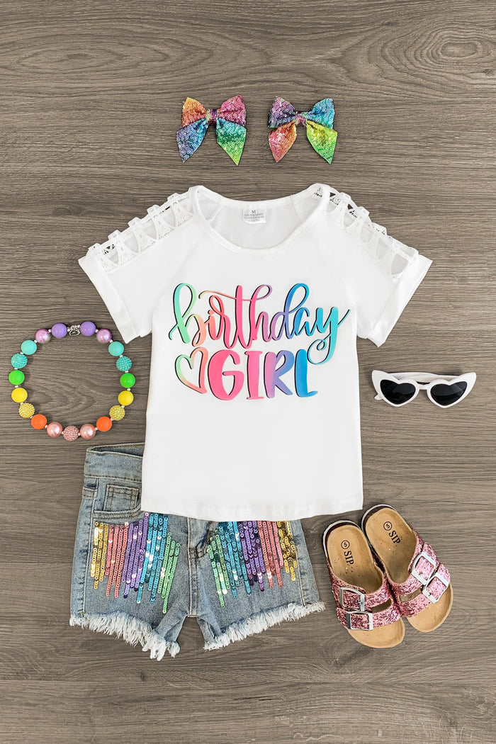 "Birthday Girl" Rainbow Sequin Denim Short Set - XXS-12-18 Months - White toddler tee with colorful "Birthday Girl" text, rainbow sequin denim shorts, two rainbow bows, white sunglasses,.